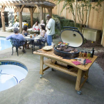 Primo Oval XL 400 Ceramic Kamado Grill On Curved Cypress Table With Stainless Steel Grates - PGCXLH - Image 2