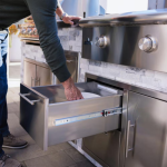 BBQGuys Signature 10 Ft Outdoor Kitchen Island w/ 32 Inch Propane Blaze LTE+ Grill & Griddle & Narrow Trash Bin | Alaska Gray w/ Black Granite - Image 10